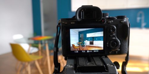 Real,Estate,Photographer,Taking,Pictures,And,Videos,At,House,In